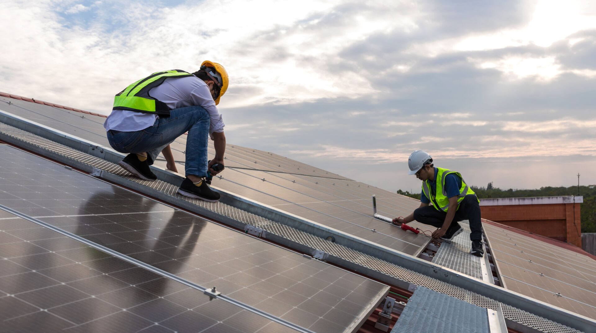 two experts are doing industrial solar panel installation